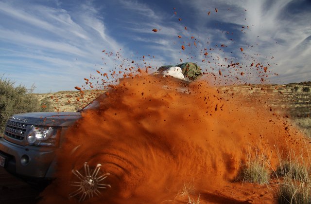 4x4 kicking up red Kalahari dust