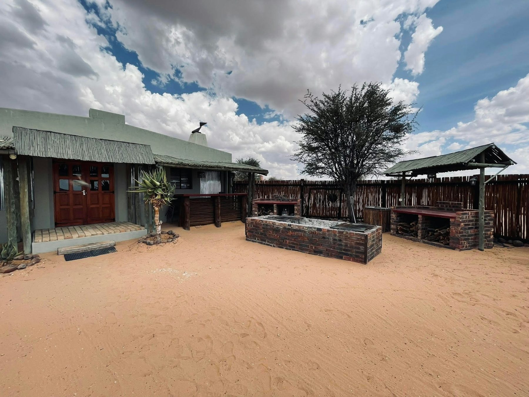 The Loch Maree farmyard under a towering Kalahari sky
