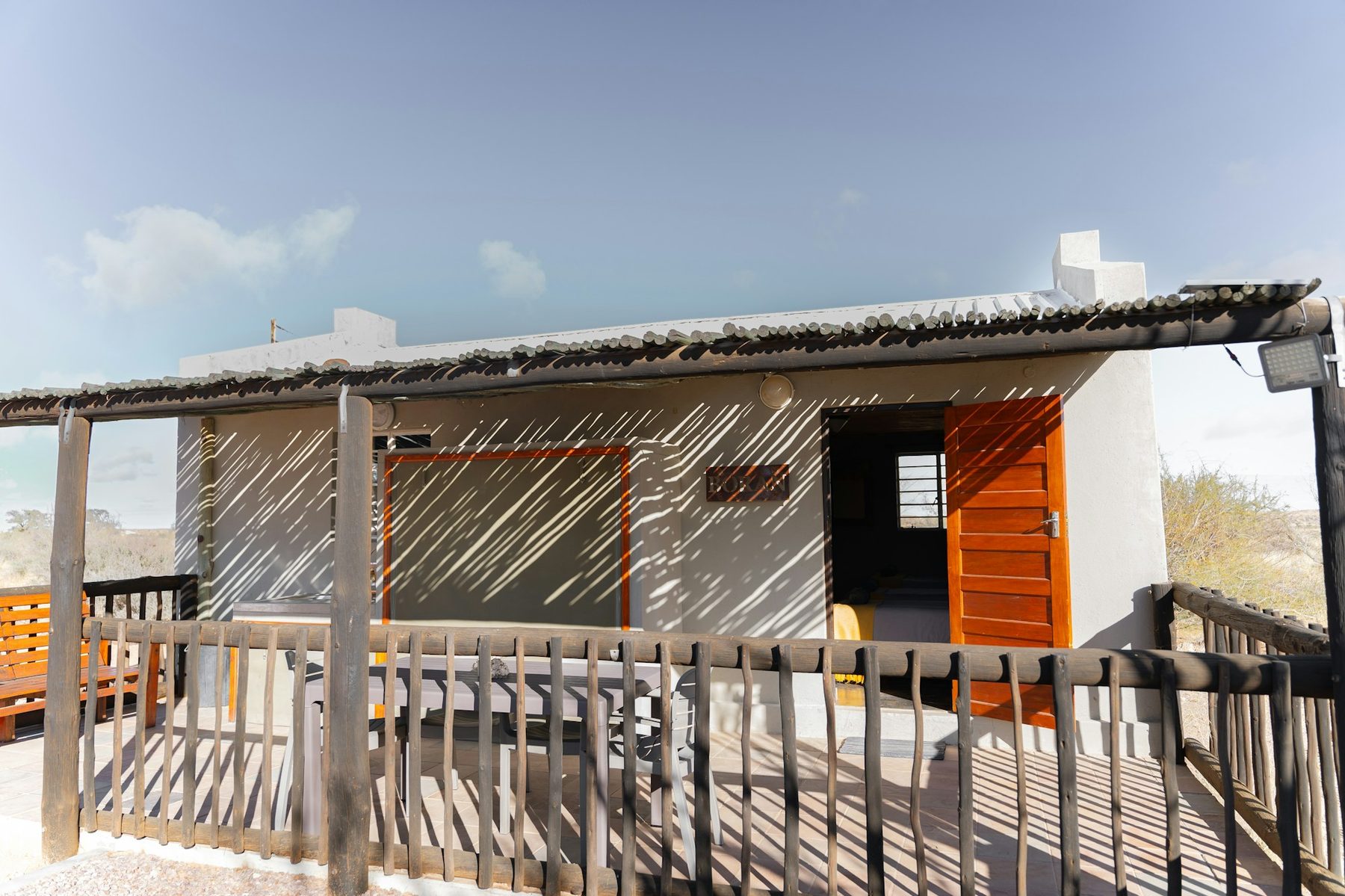 A hut veranda in afternoon light